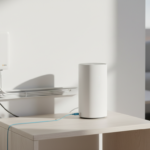 An NBN connection box mounted on a wall and a modem on a shelf with an Ethernet cable connecting them